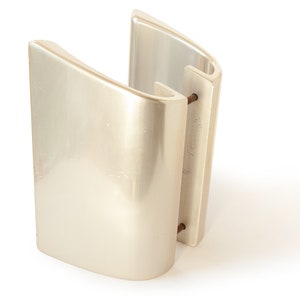May include: A pair of off-white, curved wall sconces. Each sconce has a rounded, rectangular shape with a smooth, glossy finish. The sconces are connected by two metal rods. The design is modern and minimalist.