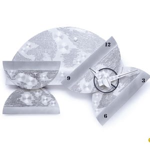 May include: A modern, silver-toned wall clock with a unique, abstract design. The clock features a circular face with black hands and a minimalist aesthetic. The clock's face is marked with the numbers 3, 6, 9, and 12. The clock is made of metal and has a textured surface.