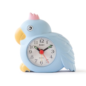 May include: A blue and yellow plastic alarm clock shaped like a parrot. The clock face is white with black numbers and hands. The clock says "BABY" and "QUARTZ" on the face.