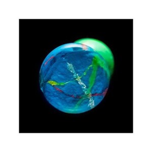 May include: A blue bouncy ball with green, pink, and white swirls. The ball is slightly out of focus and appears to be in motion.
