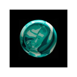 May include: A green and white marbled bouncy ball.