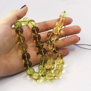 Massive Islam prayer beads Misbaha Tesbih made of genuine green color Caribbean amber. 

Not pressed, not glued, genuine amber

Intense Green color

 33   13 mm diameter ideal round amber beads, 2 separators