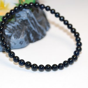 May include: A black beaded bracelet with round beads.