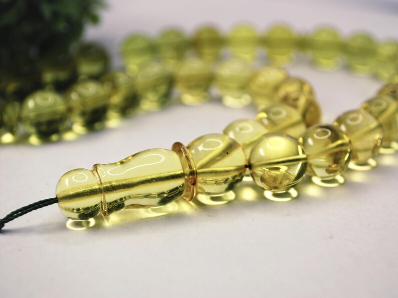 Massive Islam prayer beads Misbaha Tesbih made of genuine green color Caribbean amber. 

Not pressed, not glued, genuine amber

Intense Green color

 33   13 mm diameter ideal round amber beads, 2 separators