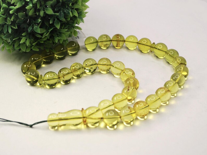 Massive Islam prayer beads Misbaha Tesbih made of genuine green color Caribbean amber. 

Not pressed, not glued, genuine amber

Intense Green color

 33   13 mm diameter ideal round amber beads, 2 separators