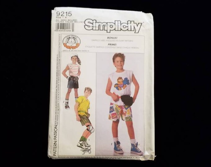 Vintage Simplicity 9215 boys' shorts, bicycle bag, and knit tops sewing pattern.  Garfield. 1989.  New UNCUT
