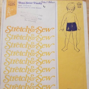 May include: A vintage sewing pattern for boys' swim trunks, featuring a yellow background with the text "Stretch & Sew" repeated multiple times. The pattern is designed exclusively for knit fabrics by Ann Person. The pattern number is 1225.
