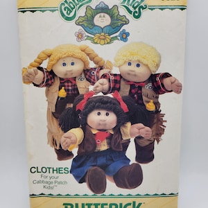 May include: A Butterick sewing pattern envelope for Cabbage Patch Kids clothes, number 6826. The package features illustrations of three dolls wearing outfits including vests, plaid shirts, and skirts, with the Cabbage Patch Kids logo at the top.