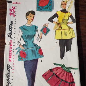 May include: Vintage Simplicity sewing pattern for a 35c apron. The pattern includes three different styles: a blue apron with red flower pockets, a yellow apron with a gathered skirt, and a red apron with a gathered skirt and a green sash. The pattern is labeled "Simple to Make" and includes instructions for sewing the apron.