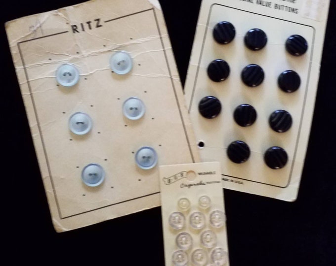 Vintage button cards with black, blue, and white buttons