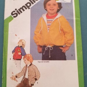 May include: Simplicity sewing pattern number 9819 for a child's jacket. The pattern includes three different views of the jacket, one in yellow, one in red, and one in brown. The pattern is for size 3 child.