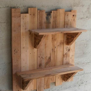 May include: A rustic wooden wall shelf with two shelves. The shelf is made from reclaimed wood planks and has a natural wood finish.