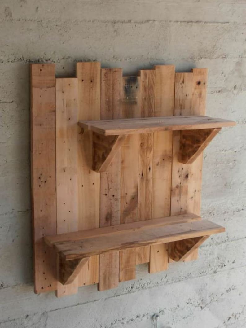 May include: A rustic wooden wall shelf with two shelves. The shelf is made from reclaimed wood planks and has a natural wood finish.