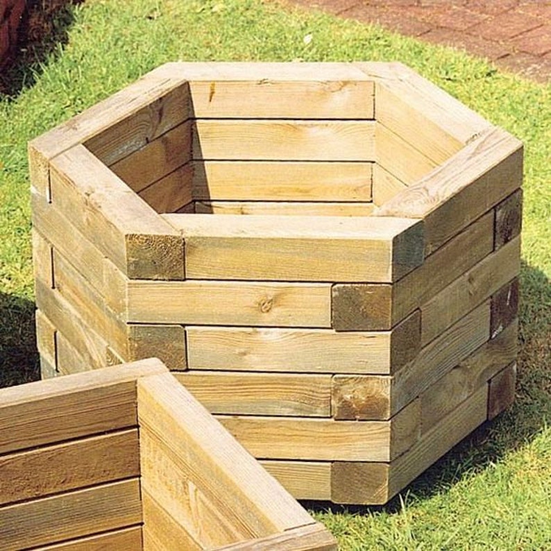 May include: A hexagonal wooden planter made of stacked planks. The planter is empty and ready for planting.