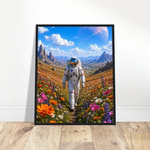 May include: A framed print showing an astronaut in a white spacesuit, walking through a field of vibrant wildflowers. The background features mountains, a blue sky, and a large planet, creating a surreal landscape.