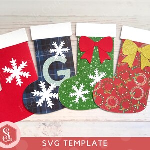 May include: Four Christmas stockings in red, green, and patterned designs. Each stocking has a white cuff and a snowflake or bow embellishment. The stockings are arranged on a light wood surface. The text "SVG TEMPLATE" is at the bottom.