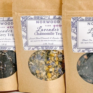 May include: Three brown paper bags with clear windows showing different types of loose leaf tea blends. The bags are labeled "Norwood Farm Lavender Earl Grey Tea", "Norwood Farm Lavender Chamomile Tea", and "Norwood Farm Lavender Rose Tea".