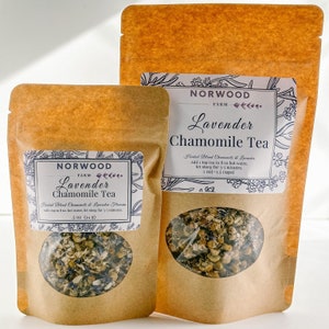 May include: Two brown paper bags with labels that say "Norwood Farm Lavender Chamomile Tea". The bags contain dried lavender and chamomile flowers. The labels include instructions for brewing the tea.