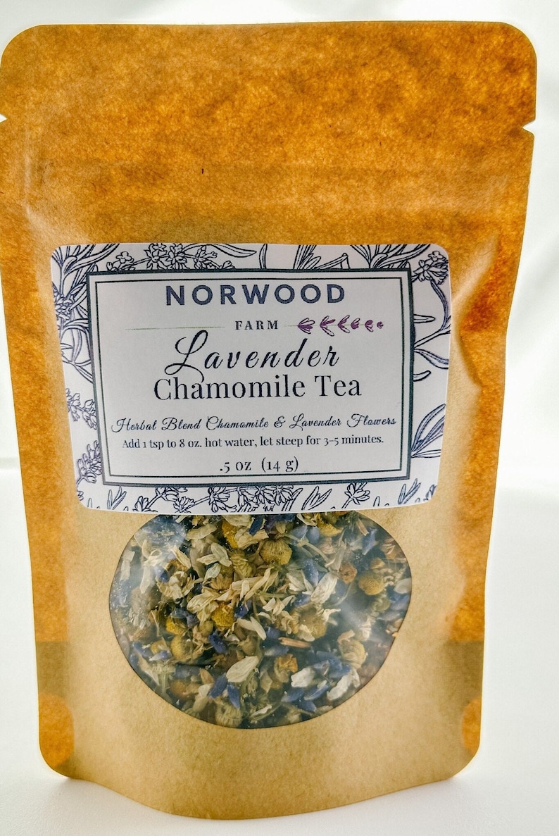 May include: A brown paper pouch with a white label that reads "NORWOOD FARM Lavender Chamomile Tea" and "Herbal Blend Chamomile & Lavender Flowers". The label also includes instructions for brewing the tea: "Add 1 tsp to 8 oz. hot water, let steep for 3-5 minutes." The pouch contains a blend of dried chamomile and lavender flowers.