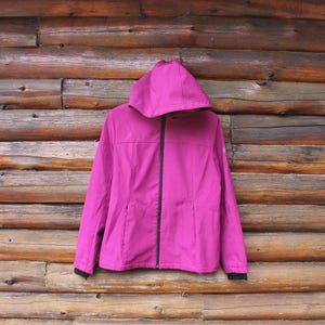 May include: A magenta hooded jacket with a zip closure. The jacket has a smooth, shiny finish.
