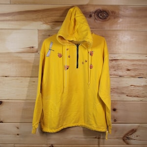 Può includere: Felpa con cappuccio gialla con chiusura a zip a metà e un design con libellula e coccinella.