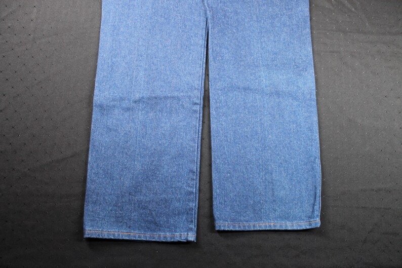 May include: A pair of blue denim jeans with a straight leg fit.