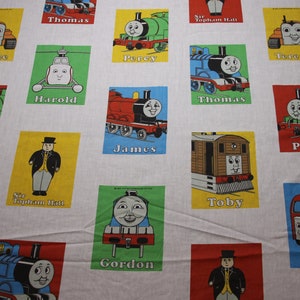 May include: A colourful fabric featuring images of Thomas the Tank Engine characters. The fabric showcases various characters, including Thomas, Percy, Gordon, James, Toby, Harold, and Sir Topham Hatt. Each character is depicted in their signature colours and designs, with their names printed below.