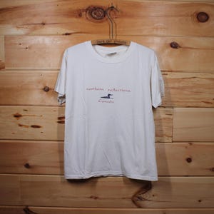 May include: White t-shirt with a red graphic of a loon and the text "northern reflections Canada".