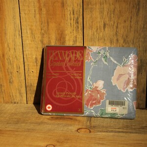 May include: Texmade Signature Collection packaging for a blue and pink floral duvet cover. The packaging features a red label with the text "Texmade Signature Collection" and "Luxury Percale Le Percale De Luxe".