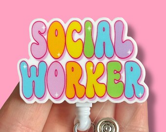 May include: A rainbow-colored badge holder with the text "SOCIAL WORKER" in bubble letters. The badge holder has a clear plastic strap and a retractable reel.