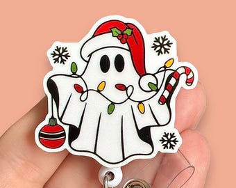 May include: A white ghost wearing a red Santa hat with a candy cane and Christmas lights. The ghost is holding a red ornament. The ghost is on a white background.