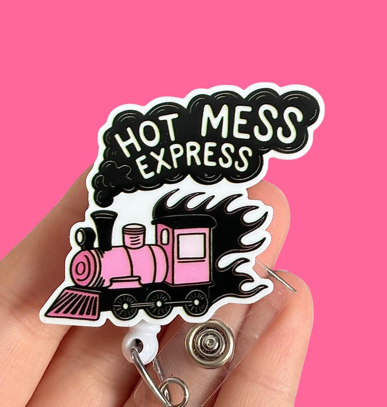 May include: A pink and black cartoon train with flames coming out of the back. The train is on a white background with the text "Hot Mess Express" in black letters.