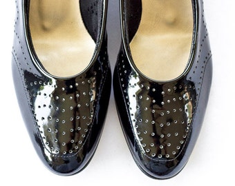 Black patent leather brogue pumps with low heel
