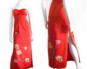 Red strapless dress with embroidered and painted flower decoration