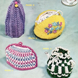May include: An assortment of knitted tea cozies in various designs and colors. Includes a purple cable-knit cozy, a yellow cozy with floral embroidery, a pink and white patterned cozy, and a green and white checkered cozy. A teacup and saucer are also visible.