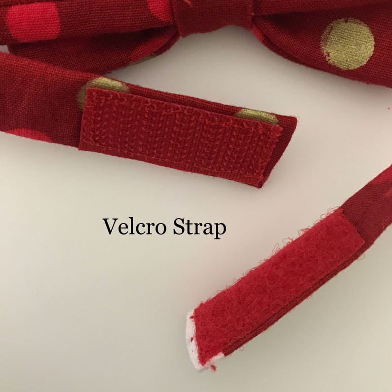 May include: Red bow tie with gold polka dots and a red velcro strap. "Velcro Strap" is written in black text below the bow tie.