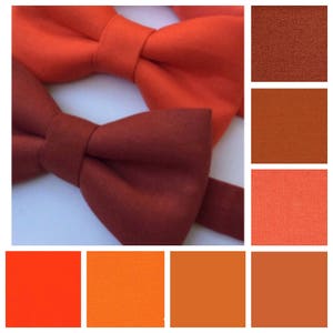May include: Close-up of two bow ties in shades of orange and red-brown. The image also includes a color palette of orange and red-brown fabric swatches. The bow ties are made of a textured fabric.