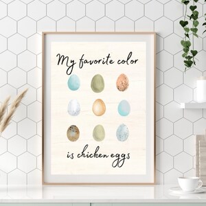 May include: A framed print with the text "My favorite color is chicken eggs" and a graphic of nine different colored eggs.