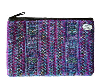 May include: A purple and blue woven zippered pouch with a label that reads "Made in Guatemala 100% Cotton".