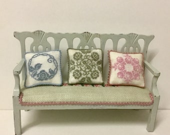 Dollhouse miniature pillow, with single-color silk embroidery on linen canvas. Scale 1:12.