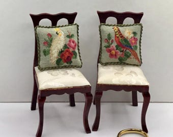 Miniature dollhouse cushion with antique design embroidered in petit point on silk gauze.