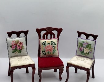 Miniature dollhouse cushion with flowers embroidered in petit point on silk gauze.