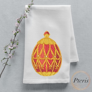 May include: A white kitchen towel with an embroidered red and gold egg design. The egg is decorated with a gold crown and intricate details.