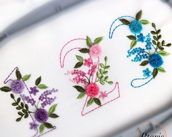 May include: Embroidered numbers 1, 2, and 3 with floral designs. The number 1 is purple, the number 2 is pink, and the number 3 is blue.