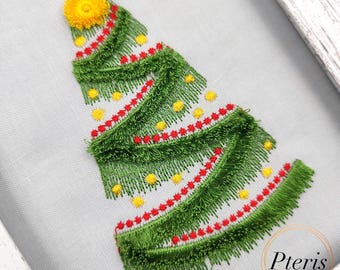 May include: Embroidered Christmas tree design with green, red, and yellow thread. The tree is decorated with a yellow star on top and red and yellow ornaments.