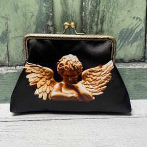 Bolso de mano con marco para monedero de satén con diseño de ángel querubín en color negro y bronce de 5,5 pulgadas y cierre cosido