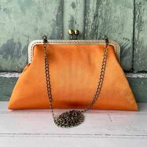 Light orange clutch best sale bag
