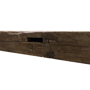 May include: A weathered, dark brown wooden beam with a rectangular cutout. The beam has a rustic, reclaimed look and is perfect for adding a touch of farmhouse charm to any space.