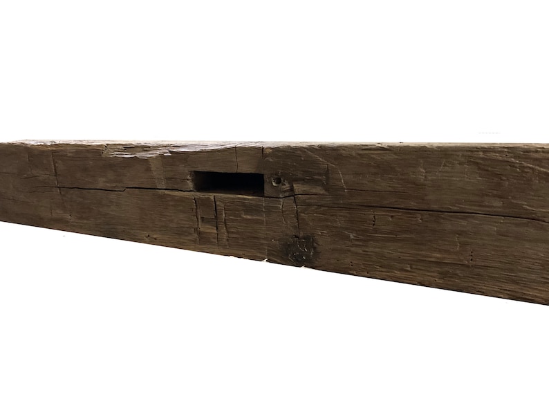 May include: A weathered, dark brown wooden beam with a rectangular cutout. The beam has a rustic, reclaimed look and is perfect for adding a touch of farmhouse charm to any space.