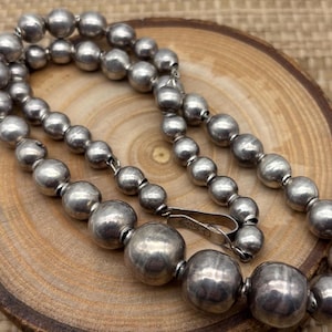 Vintage graduated Navajo pearl sterling bead necklace with moderate patina.